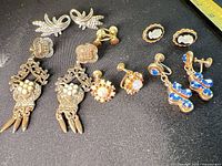 Group view of all earrings laid out on black fabric