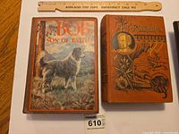 Front covers of both books side-by-side with ruler for scale