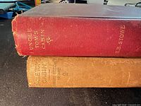 Spine view of both cloth hardcovers showing titles and wear