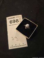 Ring in presentation box with lot tag visible