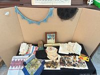 Overall lot overview showing linens, trims, coin purse, buttons and small framed photo
