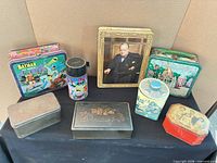 Group shot of all nine tins, lunchboxes and thermos