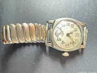 Entire watch on expansion bracelet, dial visible