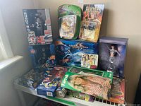 Overview of all boxed dolls, figures and puzzle displayed on shelf