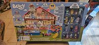 Front view of Bluey Ultimate Mega Set in original box showing playhouse, vehicle, and figures