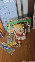 Full lot showing Barney Rubble cookie jar, Pebbles and Bam Bam salt shakers, sealed Betty Rubble poseable figure, and background box with Flintstones characters.