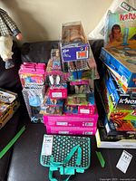 Full view showing stacked boxed Ken dolls and Barbie Fashionistas accessories, various packaging colors and designs