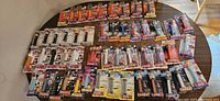Large assortment of PEZ dispensers in sealed packaging arranged on table