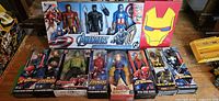 Overview of Marvel and DC action figures, all new in box, including Avengers Titan Hero Series boxed set and individual figures.