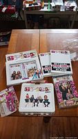 Overall photo clearly showing all Spice Girls merchandise including lunch box, albums, bubble gum, diary set, and figures.