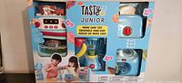 Front view of Tasty Junior Mini Chef toy set in original packaging, showing stove, toaster, frying pan, and accessories.