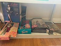 Overview of five sealed boxed dolls arranged on floor