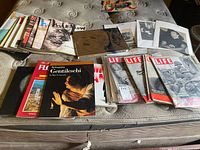 Overview of magazines, art books, comic, and mounted photos laid out