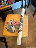 Campbell's Soup clock and rolled Andy Warhol poster on a wooden chair