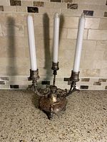 Full view with candles inserted showing three arms and ornate base