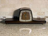 Front view of mantel clock on countertop