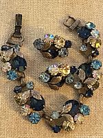 Front view of bracelet and earrings showing rhinestone colors and leaf motifs