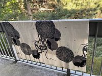 Full length of fabric draped on railing showing entire print repeat