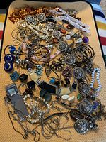 Full spread showing mixed jewelry pieces on mat