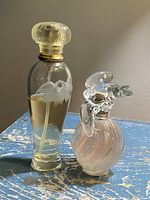 Front view of both perfume bottles showing design and fill levels