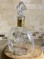 Front angled view of crystal Louis XIII decanter with stopper