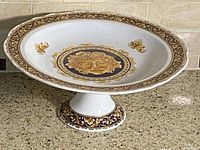 Full view of porcelain pedestal compote bowl showing rim and pedestal base