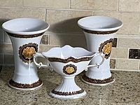 Front view of two vases and compote showing pattern and shape