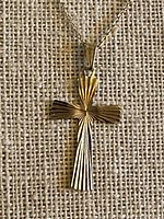 Front view of gold cross pendant on chain showing fluted sunburst design