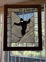 Full view of stained glass panel hanging in window
