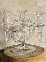Front view of clear glass Cambridge candelabra with three candle holders and two flower vases