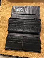 Wallet open showing ID window, card slots, checkbook compartment