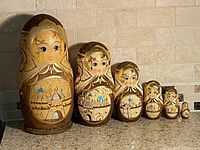 Front view of six visible dolls showing hand-painted designs