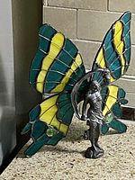 Front angled view showing stained glass wings and metal fairy figure