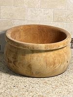 Angled view of wooden bowl showing overall shape and rim