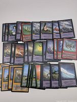 36 Wyvern trading cards laid out showing variety of fantasy-themed images and text