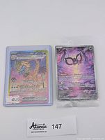 Alolan Exeggutor EX card in sleeve next to sealed Pechurant promo card