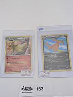 Two Pokémon holographic cards displayed side by side, Dragonite Holo #5 and Typhlosion Cracked Ice Holo #32, on white background with pricing tags.