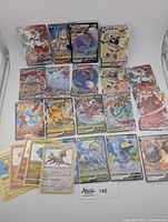 Collection of 23 Pokémon cards laid out showing front artwork including Full Art V, VMAX and shiny variants.