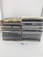 Show full stacks of 28 CDs from various artists including Alanis Morissette, Aaron Carter, Fleet Foxes, Hanson, and more.