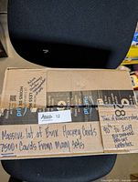 Closed cardboard box labeled with lot details describing 7500+ bulk NHL hockey cards from many sets 1990s-2019 including Black Diamond, Pro Set, Upper Deck.