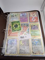 Binder page with nine assorted Pokemon cards including holo Scizor EX, reverse holo Muk, Delta Edge Armaldo