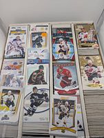 Multiple stacks of NHL hockey cards featuring players from various teams and eras, mainly from the late 1990s and early 2000s.