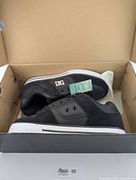 Pair of new black DC men's skate shoes size 7 inside the original box.