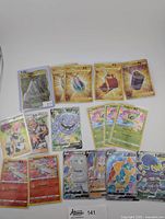 17 total Pokemon cards laid out including Full Arts, Gold cards, Amazing Rares, Trainer cards, and Pokemon V/VMAX cards, from Sword & Shield era in NM-M condition.