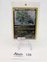 Front view of Rayquaza Cosmo Holo Pokémon card in protective holder on display stand showing clear text and holographic background.