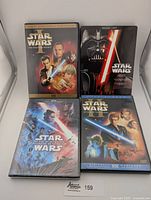 Four Star Wars DVD/Blu Ray cases displayed including The Phantom Menace, Return of the Jedi, Attack of the Clones, and one sealed copy of The Rise of Skywalker.