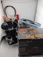 Photo showing all three Star Wars items grouped: Darth Vader bowl, Baby Grogu Chia Pet box, and Star Wars lunch box with handle.