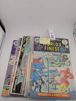 Ten vintage DC Comics World's Finest comic books arranged overlapping, showing colorful covers with Superman and Batman.