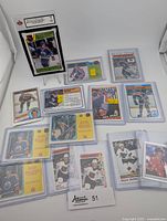 Front view of the collection showing 9 Wayne Gretzky NHL trading cards and 4 collectible stickers, all protected in sleeves and holders