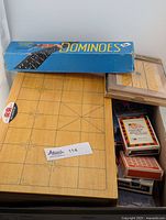 Overview of dominoes box, Chinese chess board, playing cards, and poker chips for full lot view.